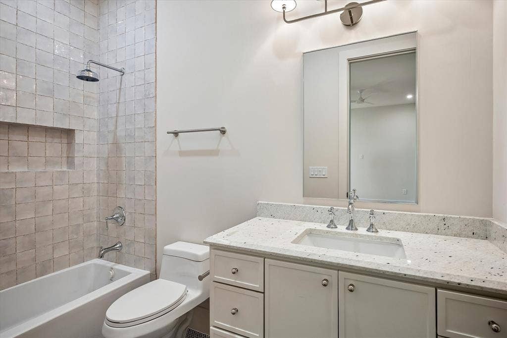 3304 Townsend Drive, Dallas, TX 75229 Bath, tub/shower combo, white glazed tile surround, stone countertop, single vanity