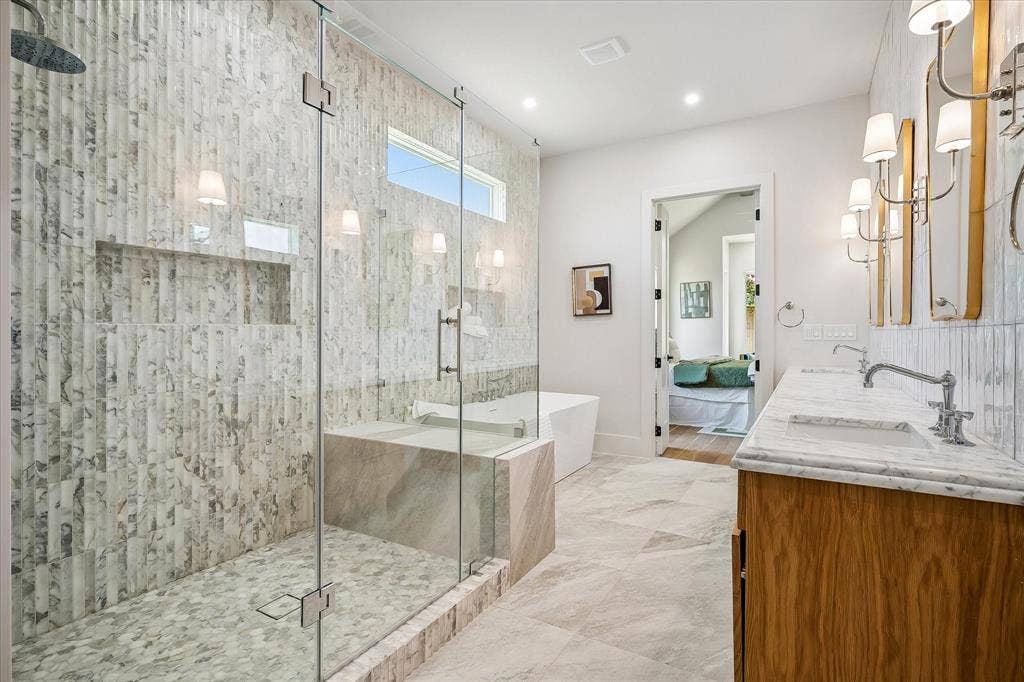 3304 Townsend Drive, Dallas, TX 75229 Primary bath, oversized frameless glass shower, Calacatta Giallo tile, freestanding soaking tub