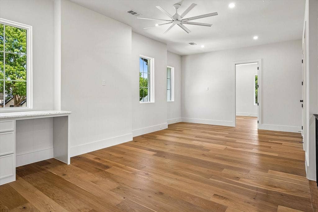 3304 Townsend Drive, Dallas, TX 75229 Secondary bedroom, hardwood floors, ceiling fan, built-in desk, multi-window views