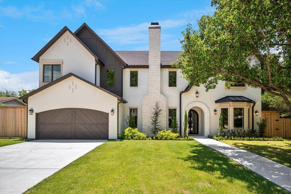 3304 Townsend Drive, Dallas, TX 75229 Front elevation, stone chimney, bay window, black standing seam metal roof accent
