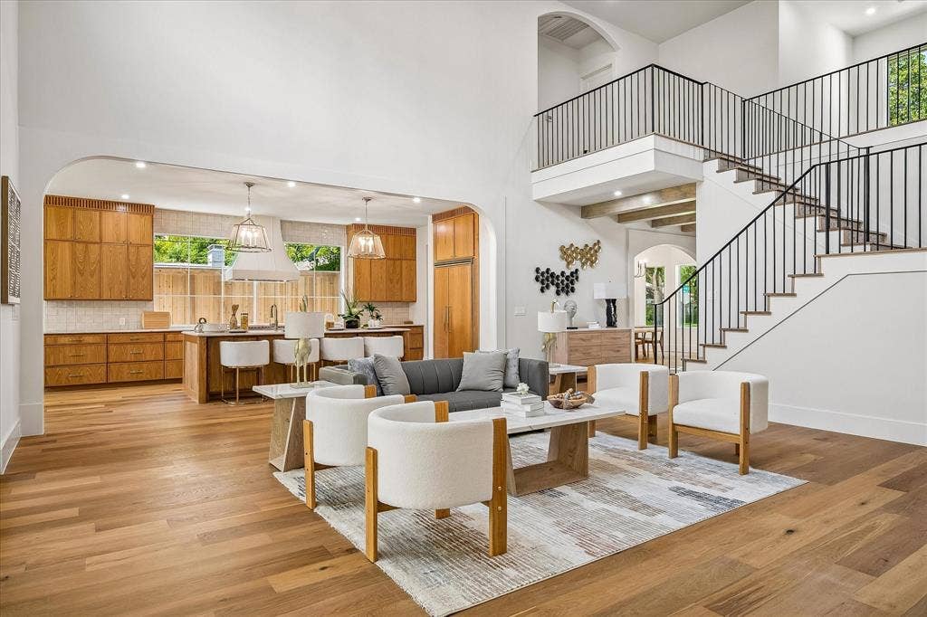 3304 Townsend Drive, Dallas, TX 75229 Open living and kitchen, arched transition, custom oak cabinetry, iron stair railing