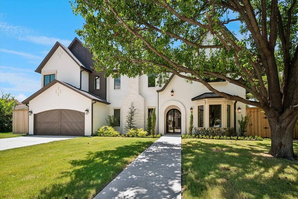 3304 Townsend Drive, Dallas, TX 75229 Maison Manor Homes new construction, stucco and stone facade, arched iron entry, wood-panel garage door