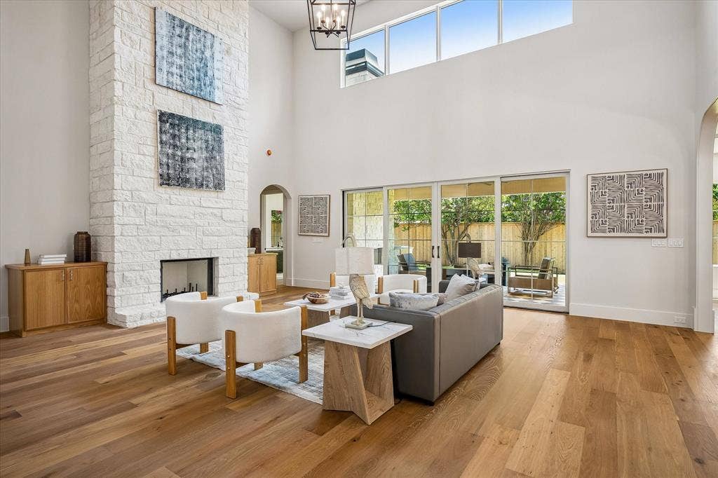 3304 Townsend Drive, Dallas, TX 75229 Stone fireplace, triple sliding glass doors to covered patio, hardwood floors
