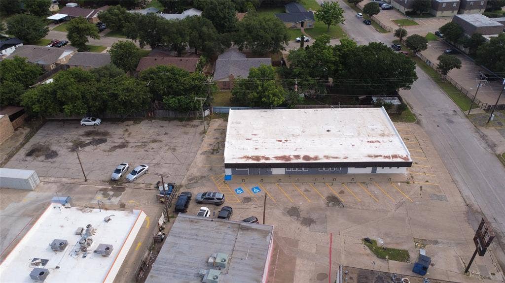 612 Michael Drive, Everman, TX 76140 Commercial building with a flat roof and asphalt parking areas