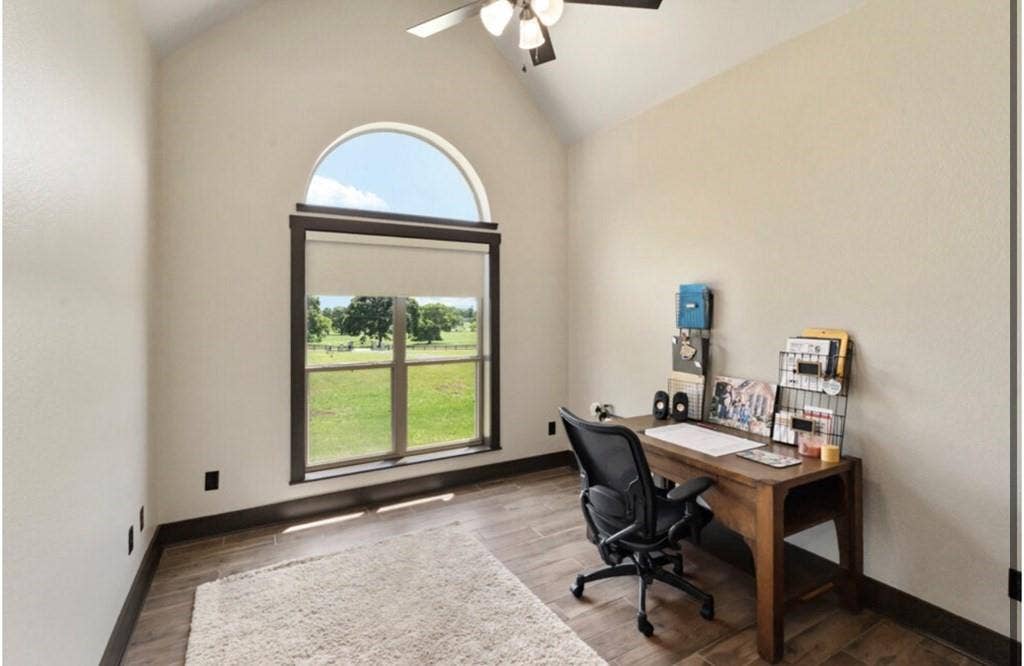 106 Timber Hill, Athens, TX 75751 Vaulted ceiling room with an arched window and wood-finish flooring
