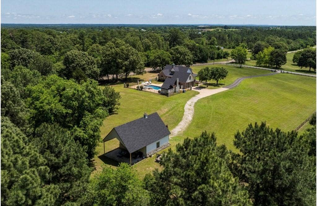 106 Timber Hill, Athens, TX 75751 Expansive property featuring a main residence, a separate auxiliary building, and a swimming pool