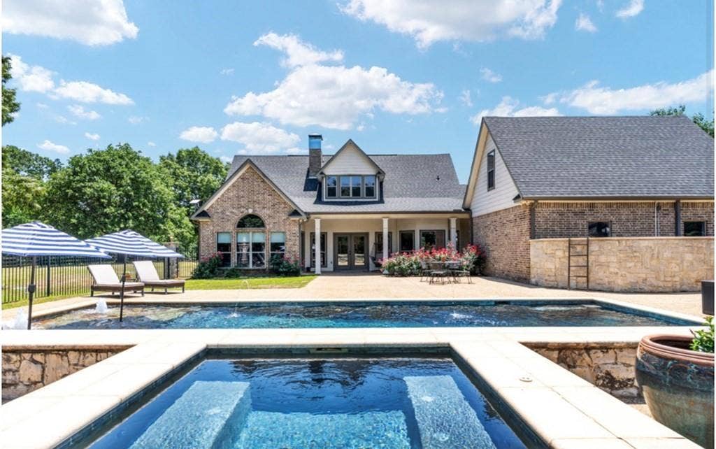 106 Timber Hill, Athens, TX 75751 Outdoor living space featuring a swimming pool with integrated spa and a surrounding stone paver patio