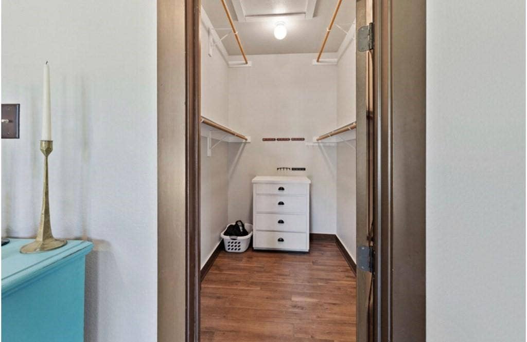106 Timber Hill, Athens, TX 75751 Walk-in closet featuring wood-finish flooring, built-in shelving, and hanging rods