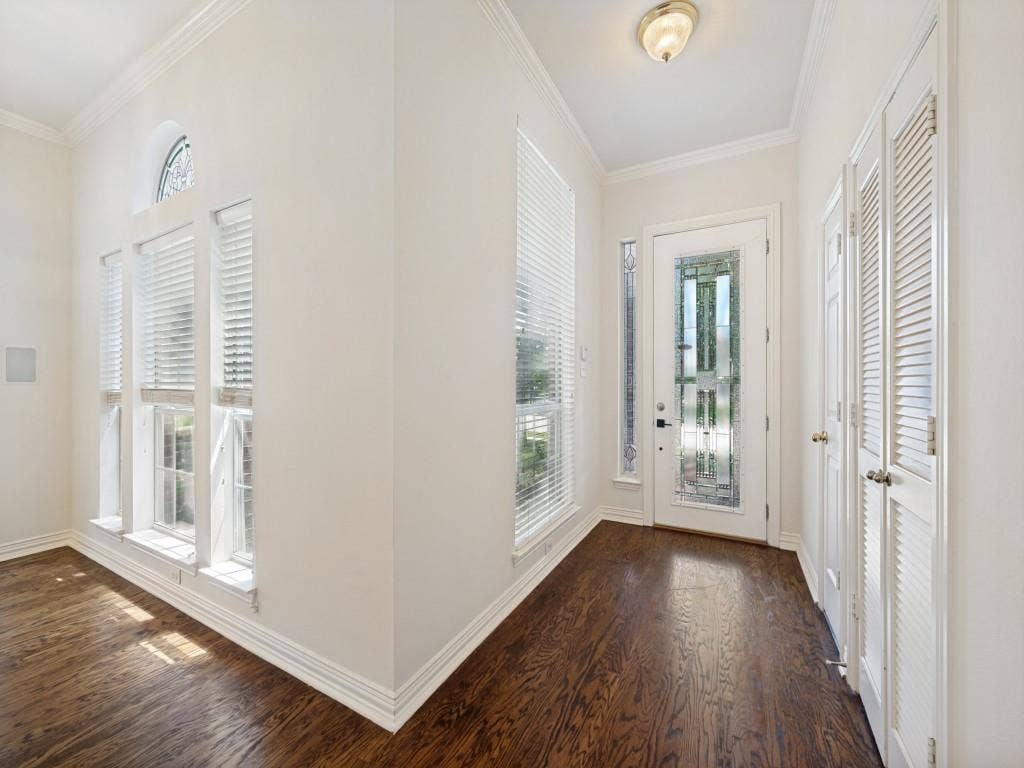 9703 Raven Lane, Irving, TX 75063 Entryway featuring wood-finish flooring and crown molding