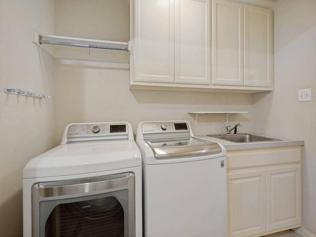 9703 Raven Lane, Irving, TX 75063 Laundry area featuring built-in cabinetry, an integrated sink, a wall-mounted drying rod, and wall hooks