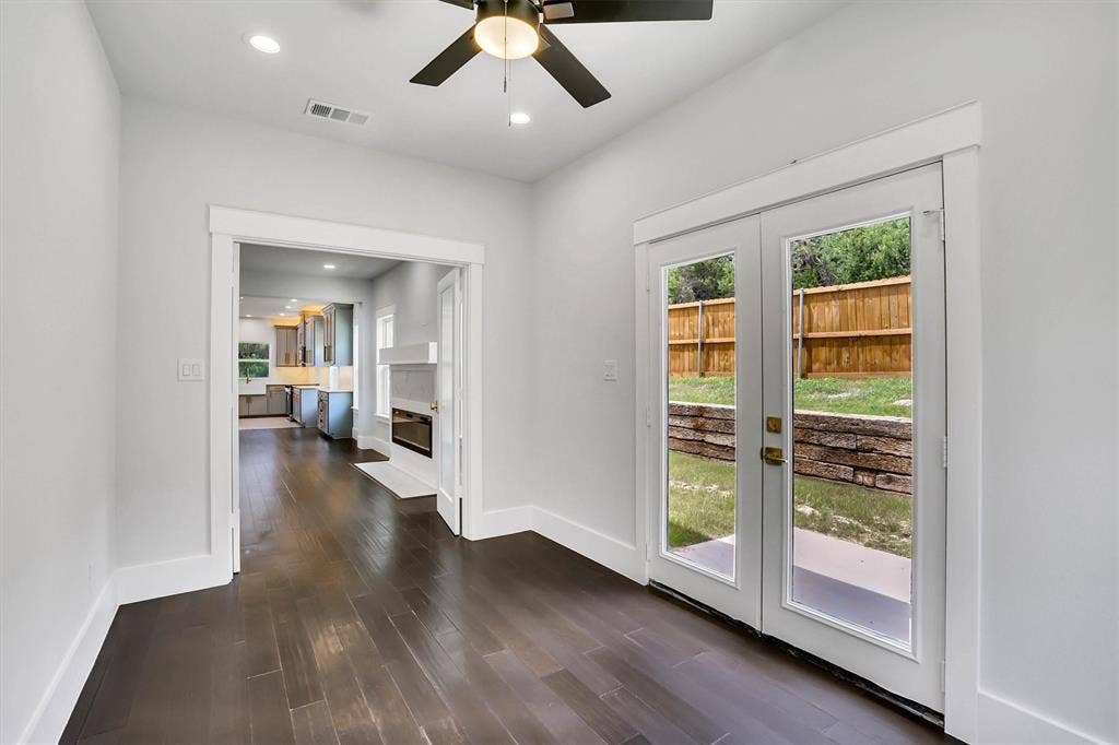 Room featuring dark wood-finish flooring and white baseboards