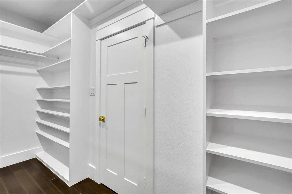 White custom shelving and built-in racks provide ample storage