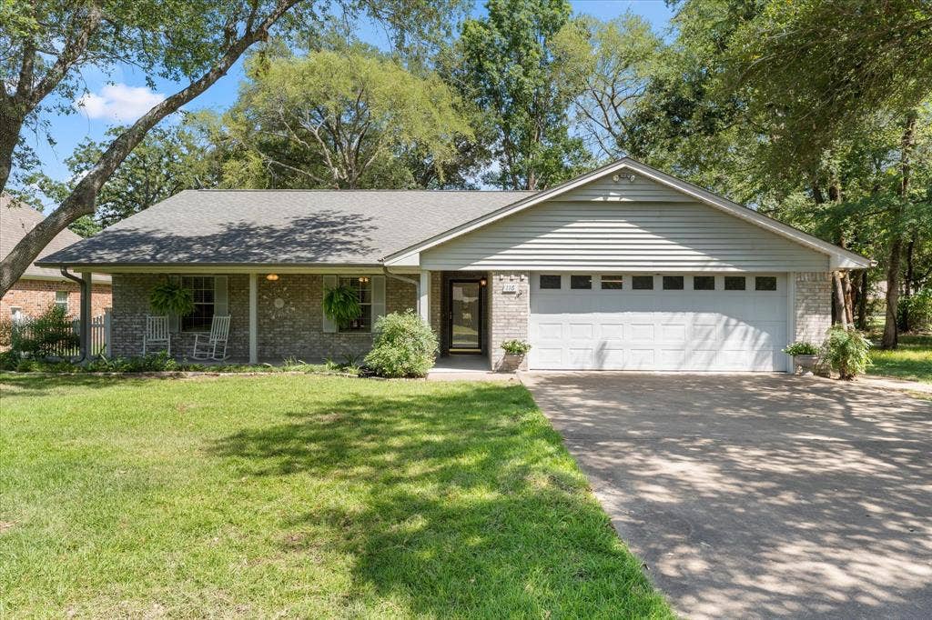 116 Meadowood Road, Enchanted Oaks, TX 75156 Brick and siding exterior with a covered front porch featuring white columns and a gray shingle roof