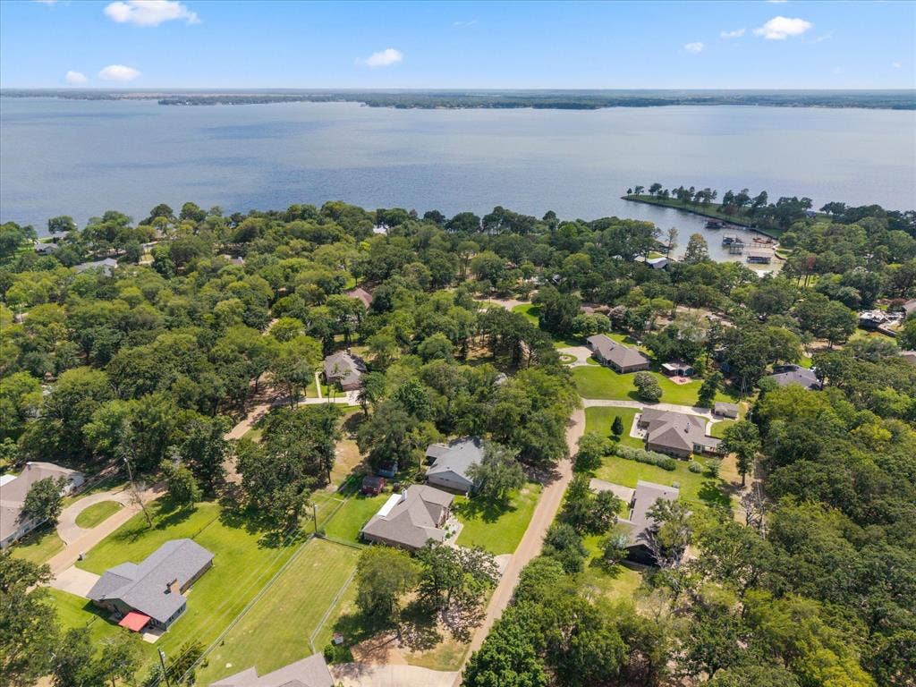 116 Meadowood Road, Enchanted Oaks, TX 75156 Expansive aerial perspective showcasing a residential area with significant tree coverage