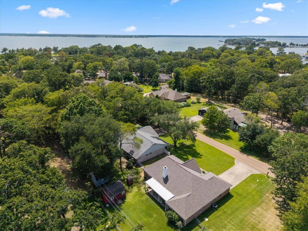 116 Meadowood Road, Enchanted Oaks, TX 75156 Aerial property showcasing a shingle roof and a concrete driveway