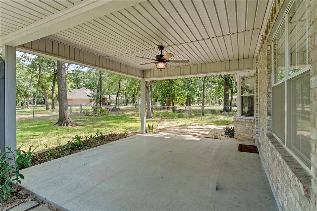 116 Meadowood Road, Enchanted Oaks, TX 75156 Expansive concrete patio featuring a ceiling fan, light brick exterior, and multiple windows