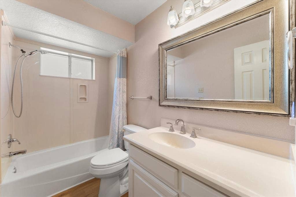 116 Meadowood Road, Enchanted Oaks, TX 75156 Bathroom featuring a single vanity with an integrated sink, polished chrome faucet, and a large framed mirror