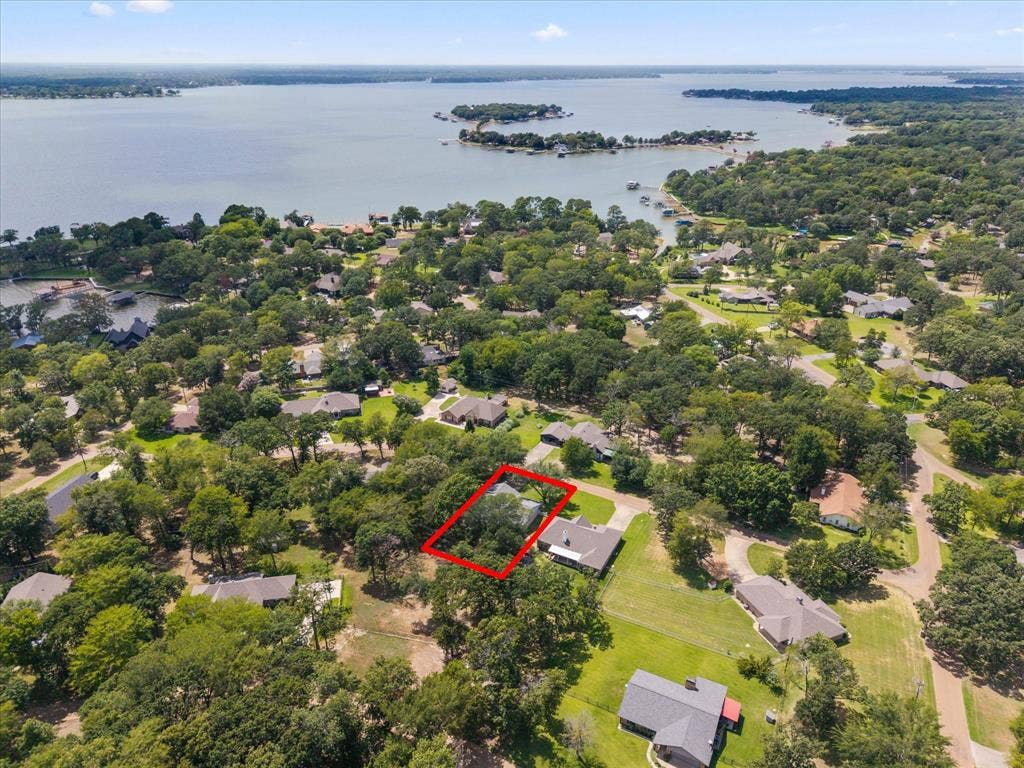 116 Meadowood Road, Enchanted Oaks, TX 75156 Aerial perspective showcasing a residential property with surrounding mature trees