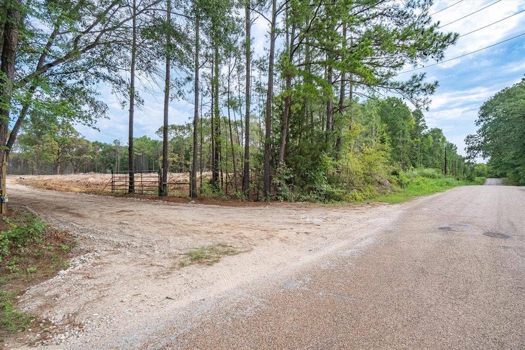 Tract 2 - TBD County Road 4307 Road, Larue, TX 75770 Gravel road frontage with a metal gate entrance leading to a partially cleared lot