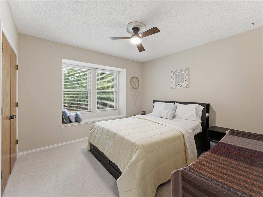 3701 Waycross Court, Arlington, TX 76016 Recessed window alcove with integrated sill seating, light carpet flooring, and a ceiling fan with integrated lighting