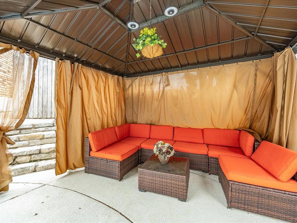 3701 Waycross Court, Arlington, TX 76016 Outdoor gazebo featuring a metal roof structure, privacy curtains, and a concrete patio surface