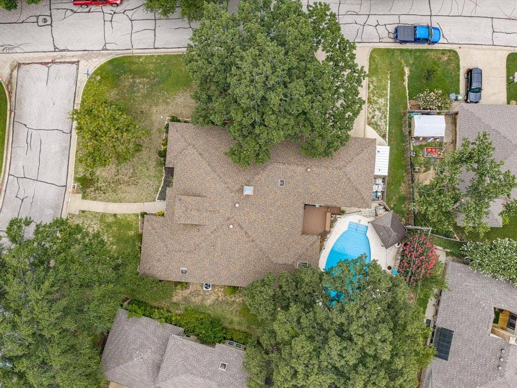 3701 Waycross Court, Arlington, TX 76016 Residential property featuring a shingle roof, mature trees, a curvilinear swimming pool, and a poolside deck