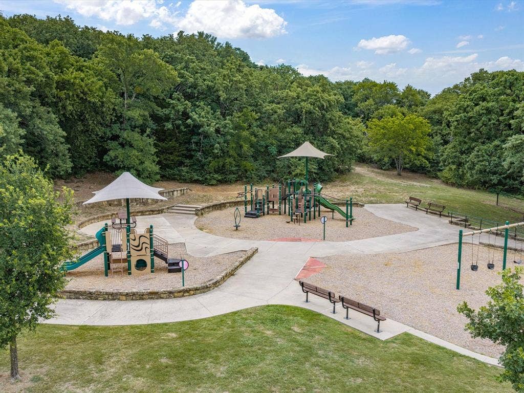 3701 Waycross Court, Arlington, TX 76016 Community playground featuring multiple play structures with sunshades, swings, and benches