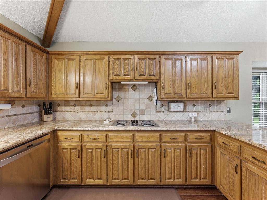 3701 Waycross Court, Arlington, TX 76016 Kitchen featuring wood cabinetry, granite-style countertops, and a tiled backsplash