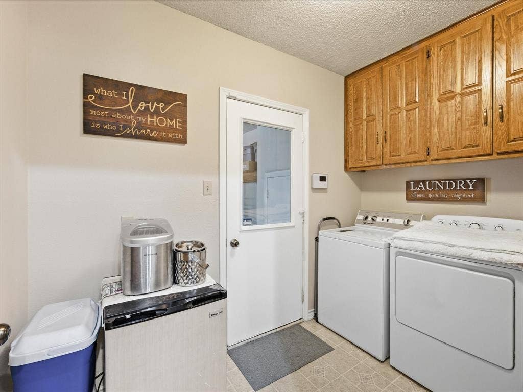 3701 Waycross Court, Arlington, TX 76016 Laundry area featuring wood-finish cabinetry, a white paneled door with a clear glass insert, and light-toned vinyl flooring