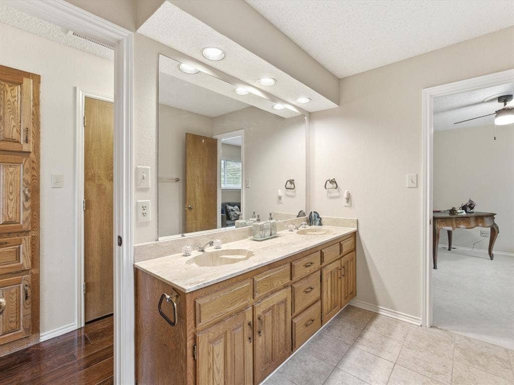 3701 Waycross Court, Arlington, TX 76016 Dual vanity with light wood cabinetry, a light-toned countertop, and undermount sinks