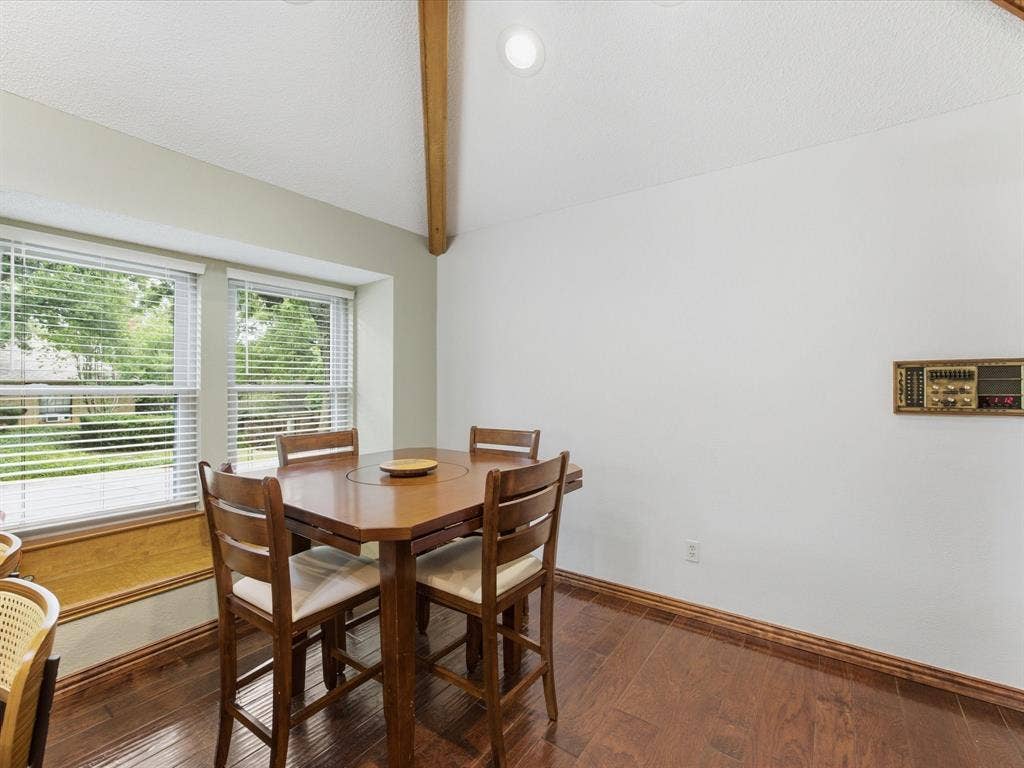 3701 Waycross Court, Arlington, TX 76016 Dining area featuring wood-finish flooring, a vaulted ceiling with exposed wood beam, recessed lighting, and a bay window with blinds