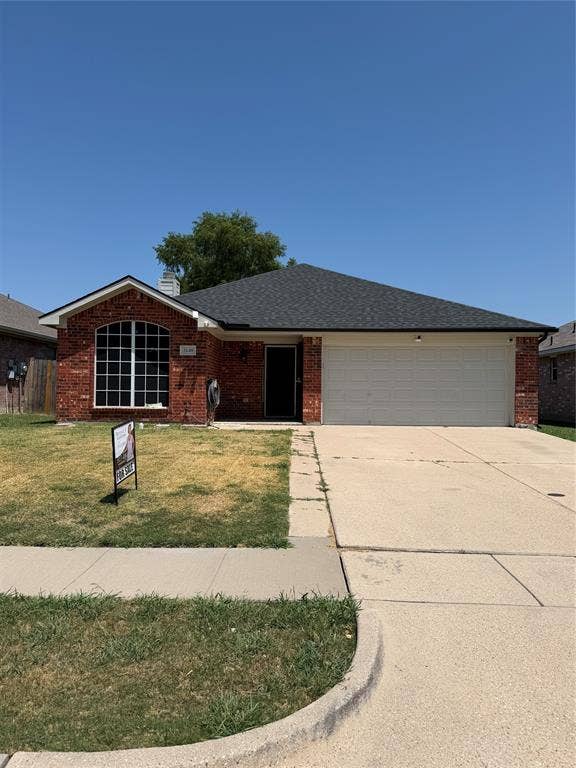 2648 Carmen Drive, Grand Prairie, TX 75052 Brick and siding exterior with an attached two-car garage