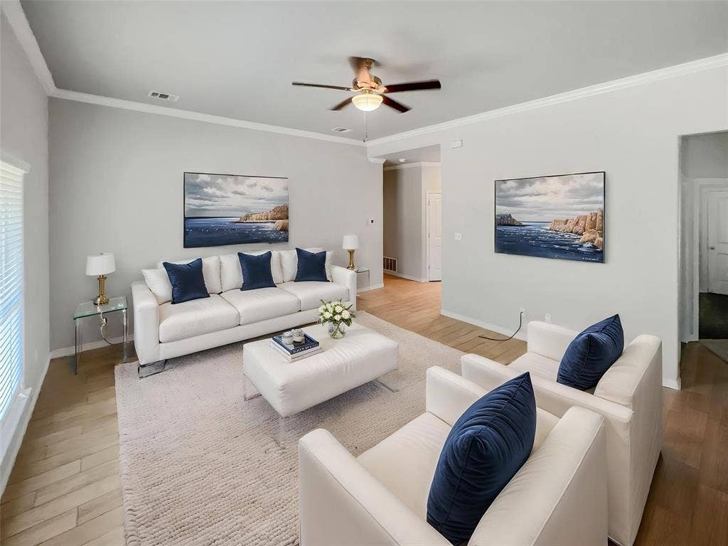 Virtually stagedLiving area featuring light wood-finish flooring and a neutral color palette