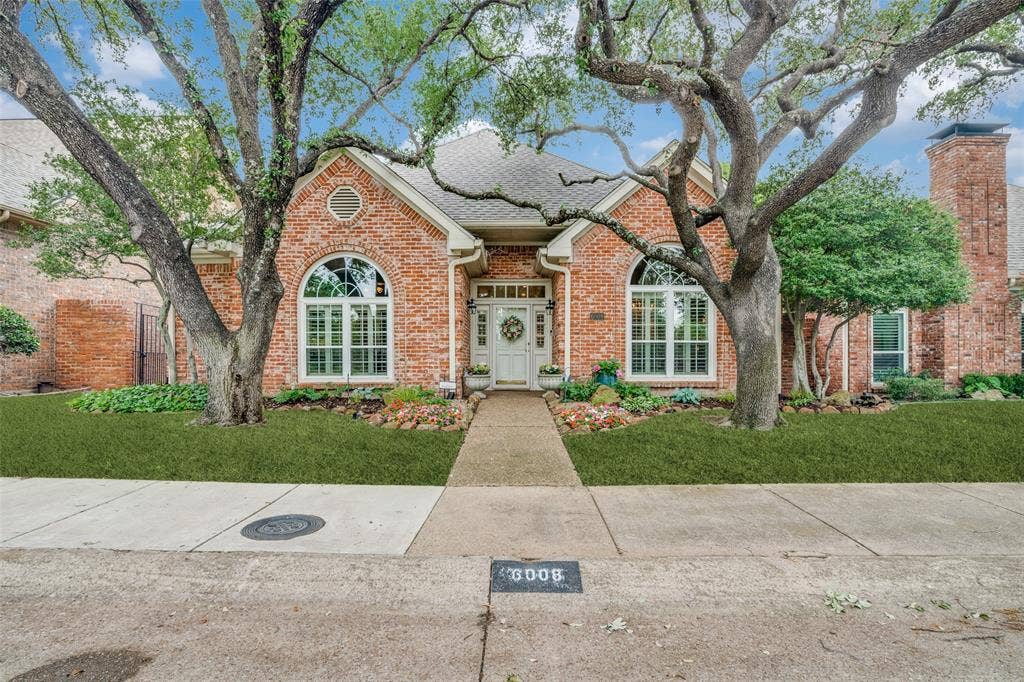 Brick exterior featuring a gabled roofline and arched windows