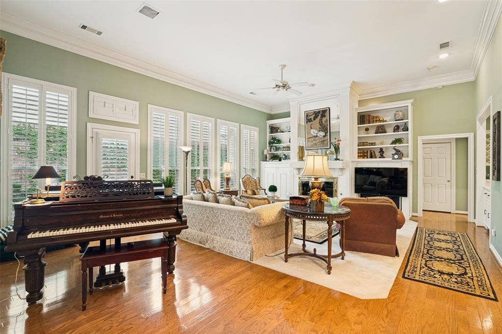 Spacious living area featuring polished wood-finish flooring