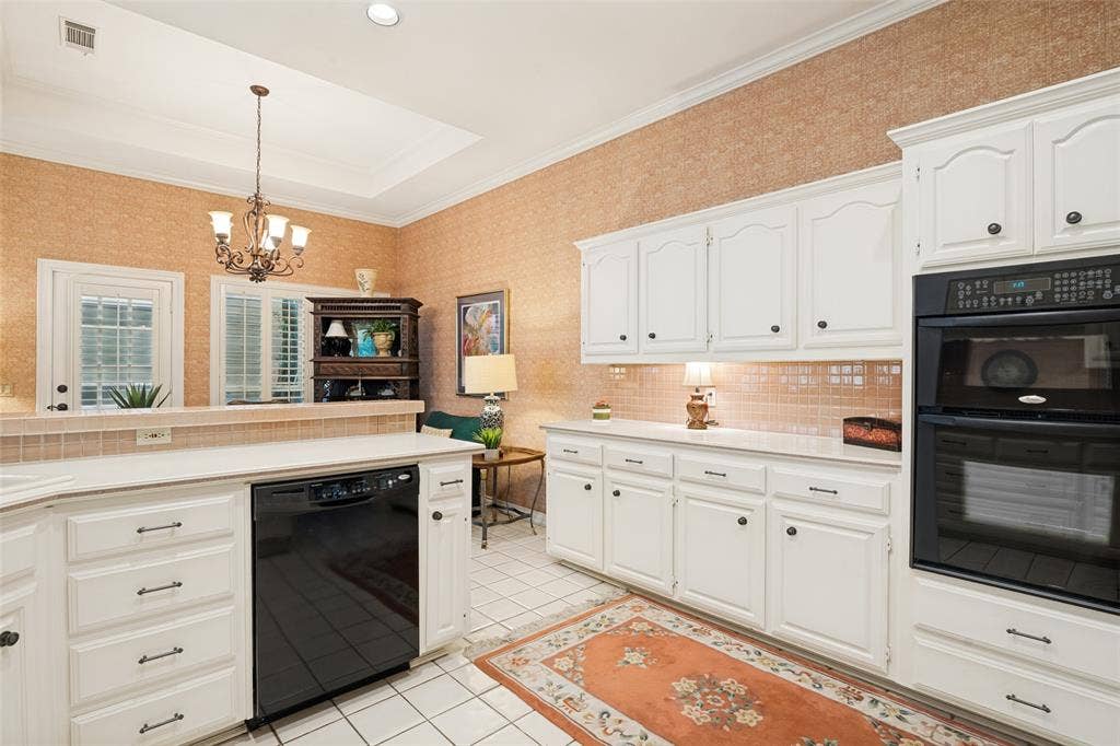 Kitchen featuring white cabinetry, built-in double ovens, and tile flooring