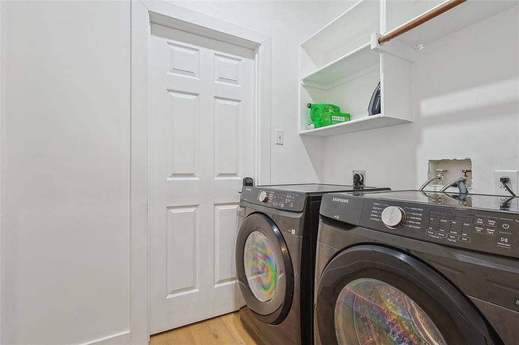 1088 Pondview Drive, Cedar Hill, TX 75104 Clothes washing area featuring light wood-style flooring, washing machine and clothes dryer, and laundry area