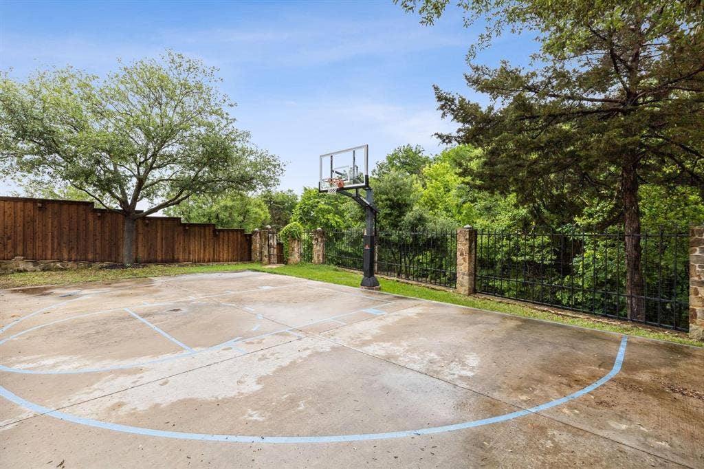 1088 Pondview Drive, Cedar Hill, TX 75104 View of basketball court with basketball hoop and fence