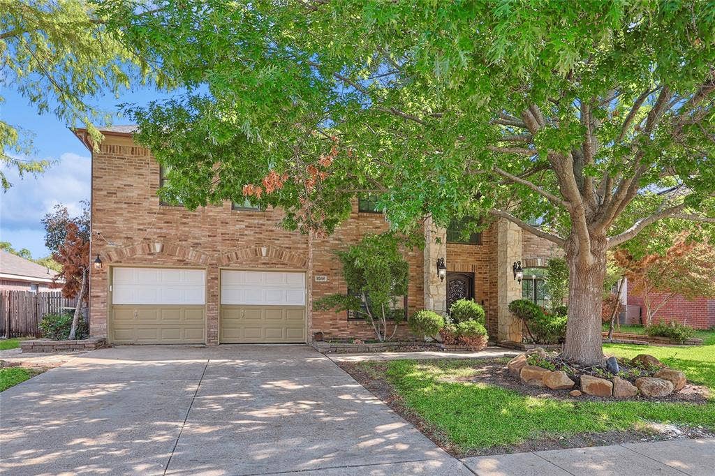 1088 Pondview Drive, Cedar Hill, TX 75104 View of front facade featuring fence, a garage, brick siding, and concrete driveway