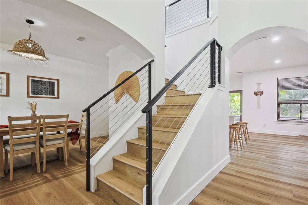 1088 Pondview Drive, Cedar Hill, TX 75104 Stairway with visible vents, baseboards, wood finished floors, recessed lighting, and arched walkways