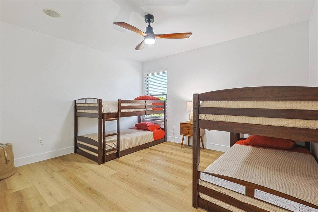 1088 Pondview Drive, Cedar Hill, TX 75104 Bedroom featuring baseboards, ceiling fan, and light wood-type flooring