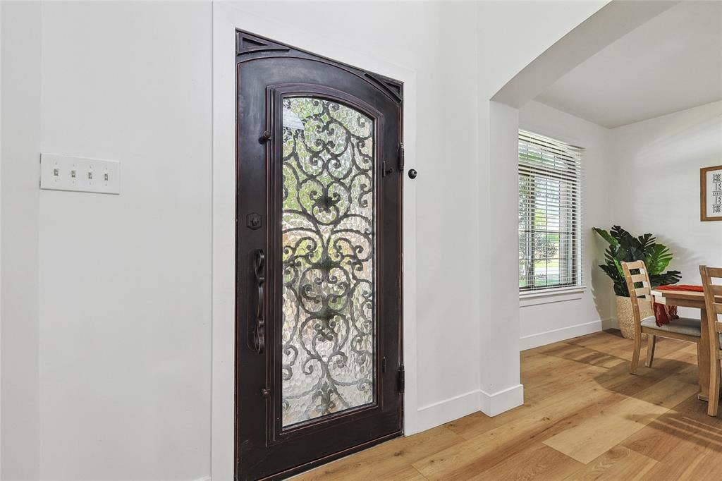1088 Pondview Drive, Cedar Hill, TX 75104 Entryway featuring arched walkways, baseboards, and light wood-type flooring