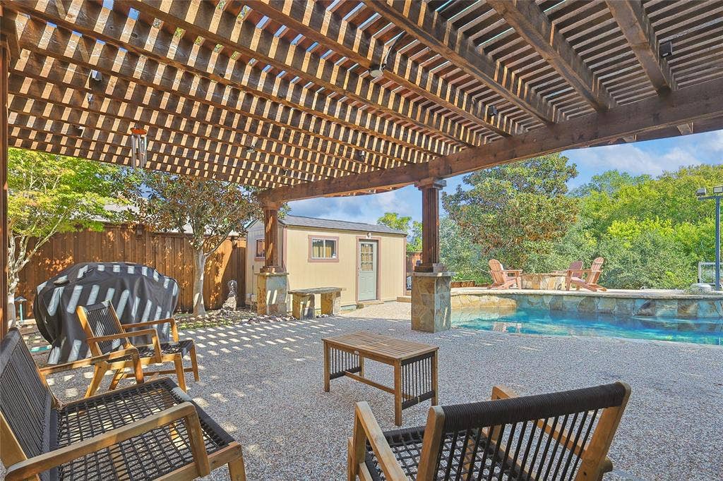 1088 Pondview Drive, Cedar Hill, TX 75104 View of patio featuring an outdoor structure, an outdoor pool, a fenced backyard, grilling area, and a pergola
