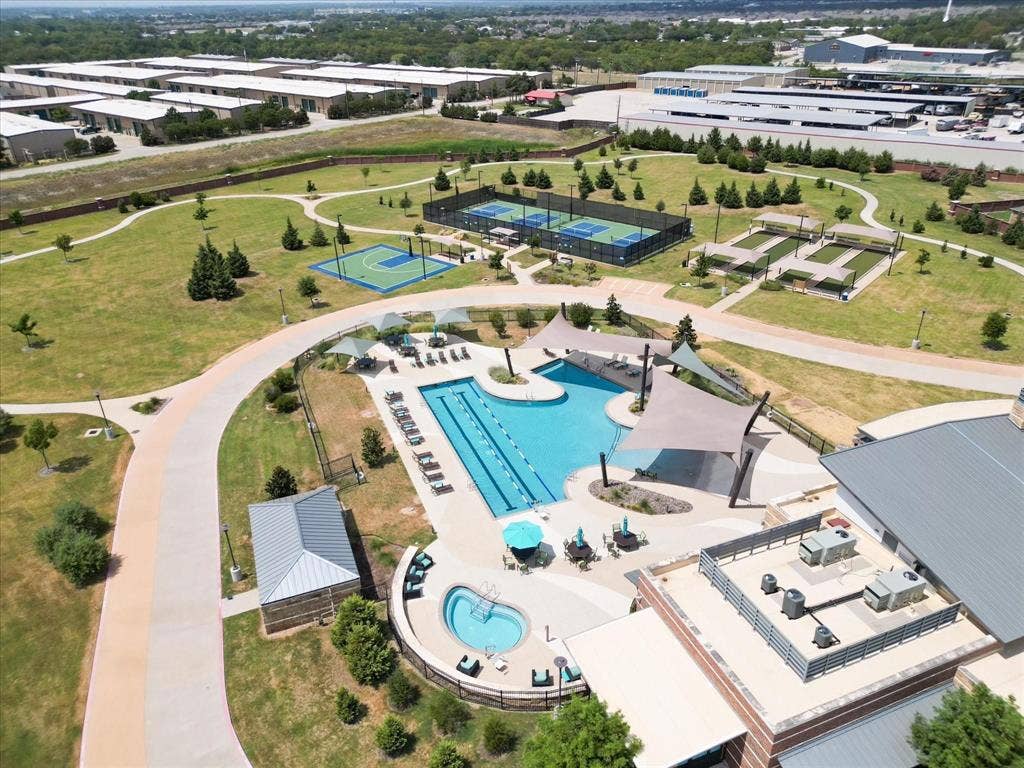 7594 Trull Brook Lane, Frisco, TX 75036 Community amenities featuring a large resort-style swimming pool, a separate spa, dedicated tennis/pickleball courts, and a basketball half-court