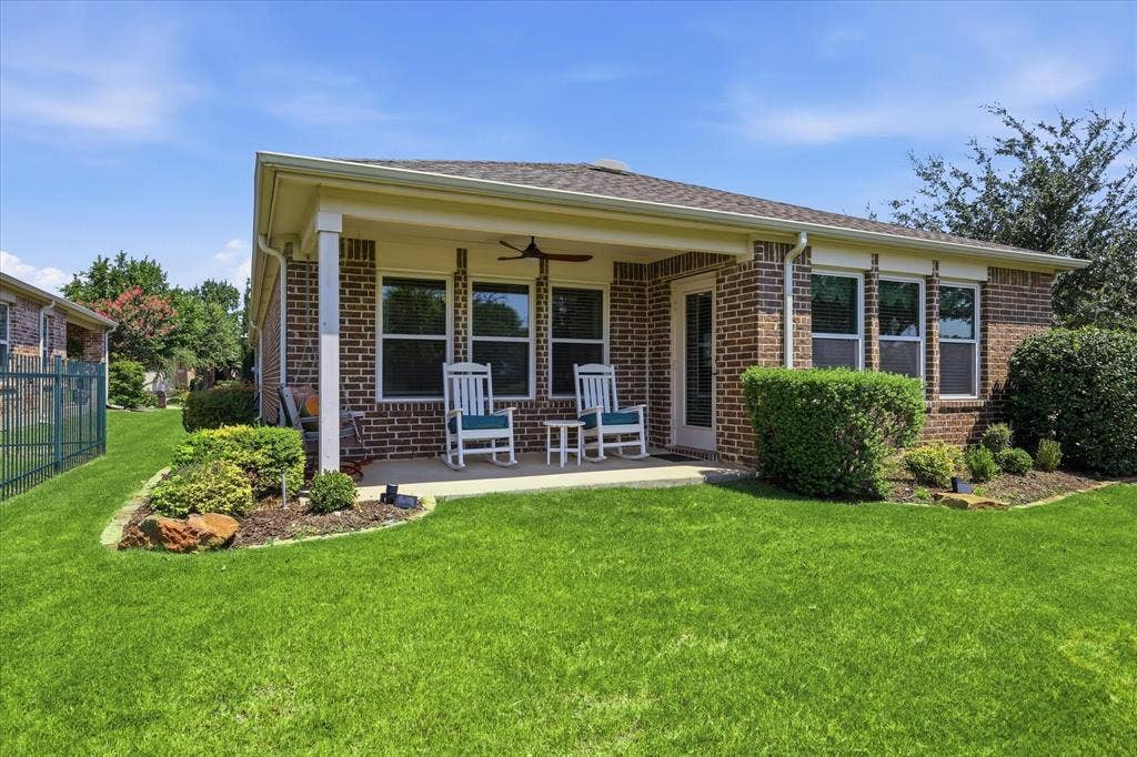 7594 Trull Brook Lane, Frisco, TX 75036 Brick exterior with a covered patio, featuring a ceiling fan and recessed lighting