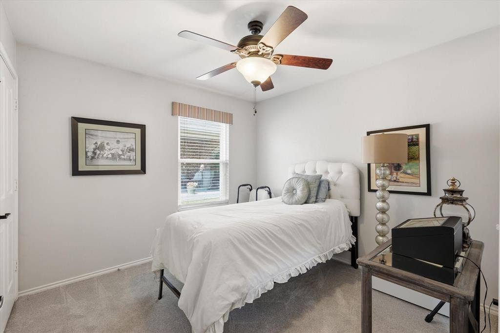 7594 Trull Brook Lane, Frisco, TX 75036 Bedroom featuring neutral wall paint, gray carpet, and a ceiling fan with light fixture