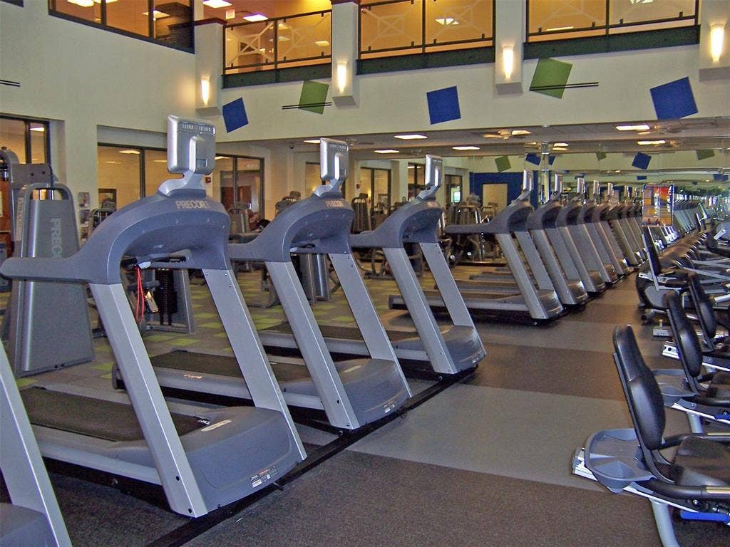 7594 Trull Brook Lane, Frisco, TX 75036 Fitness center featuring multiple treadmills, recumbent bikes, a second-story viewing area with glass railings, and accent lighting