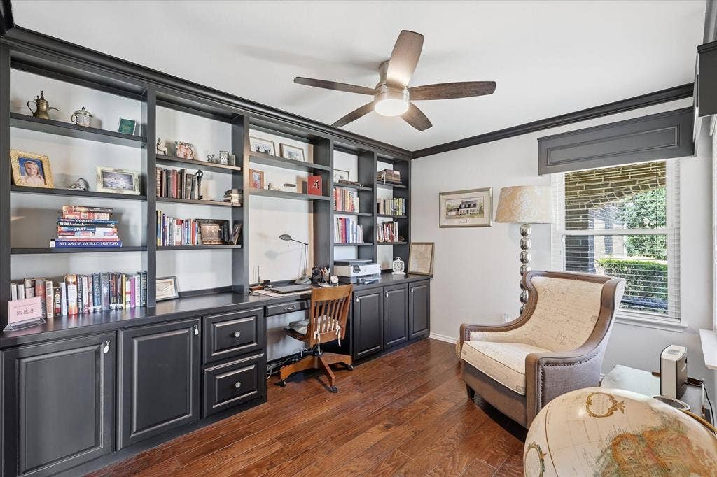 7594 Trull Brook Lane, Frisco, TX 75036 Dedicated office space featuring extensive built-in cabinetry and shelving, integrated desk, wood-finish flooring, and a ceiling fan