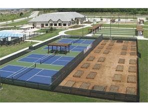 7594 Trull Brook Lane, Frisco, TX 75036 Community recreation area featuring multiple courts, a large building, and a garden plot area