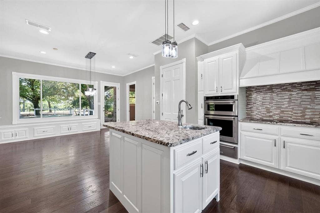 1201 Robbins Road, Athens, TX 75751 Kitchen featuring an additional sink in the island & views of breakfast nook built-in window seating.